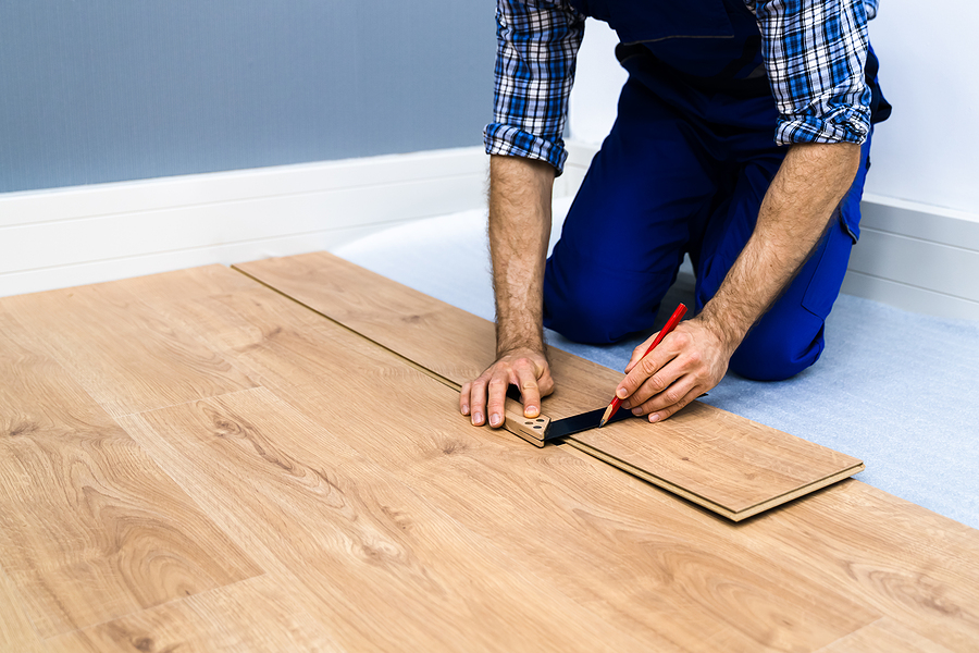 Timber floor installation Melbourne professional doing measurements and adjustments