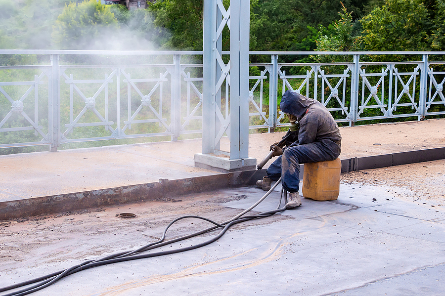 Worker with protective mask while concrete sandblasting